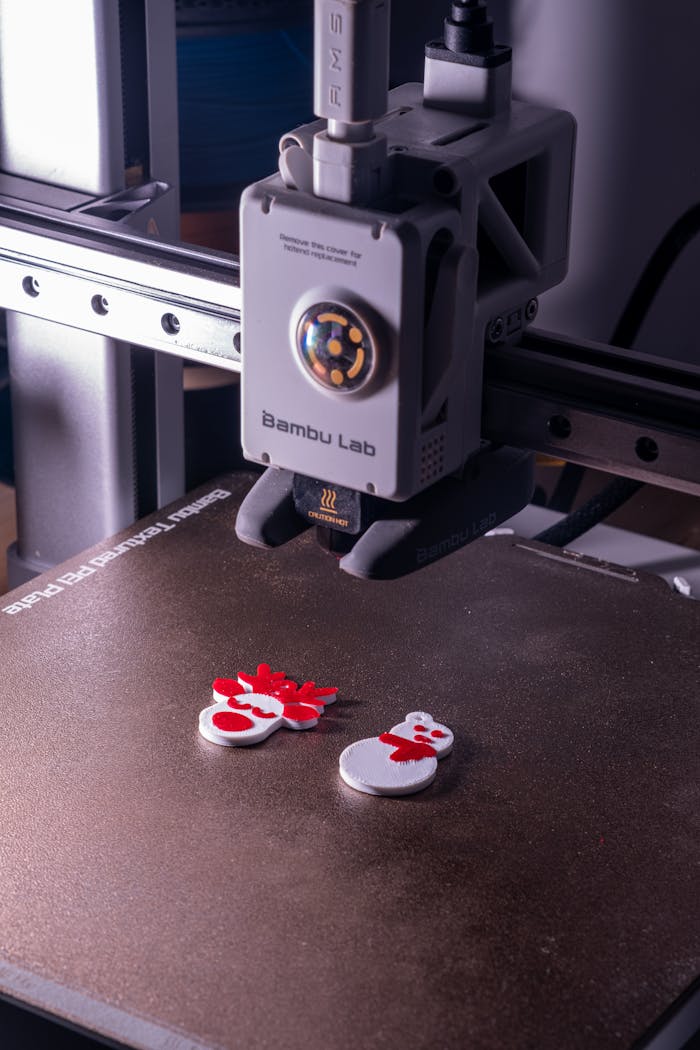 Close-up of a 3D printer creating vibrant snowman decorations, embodying modern technology and festive spirit.